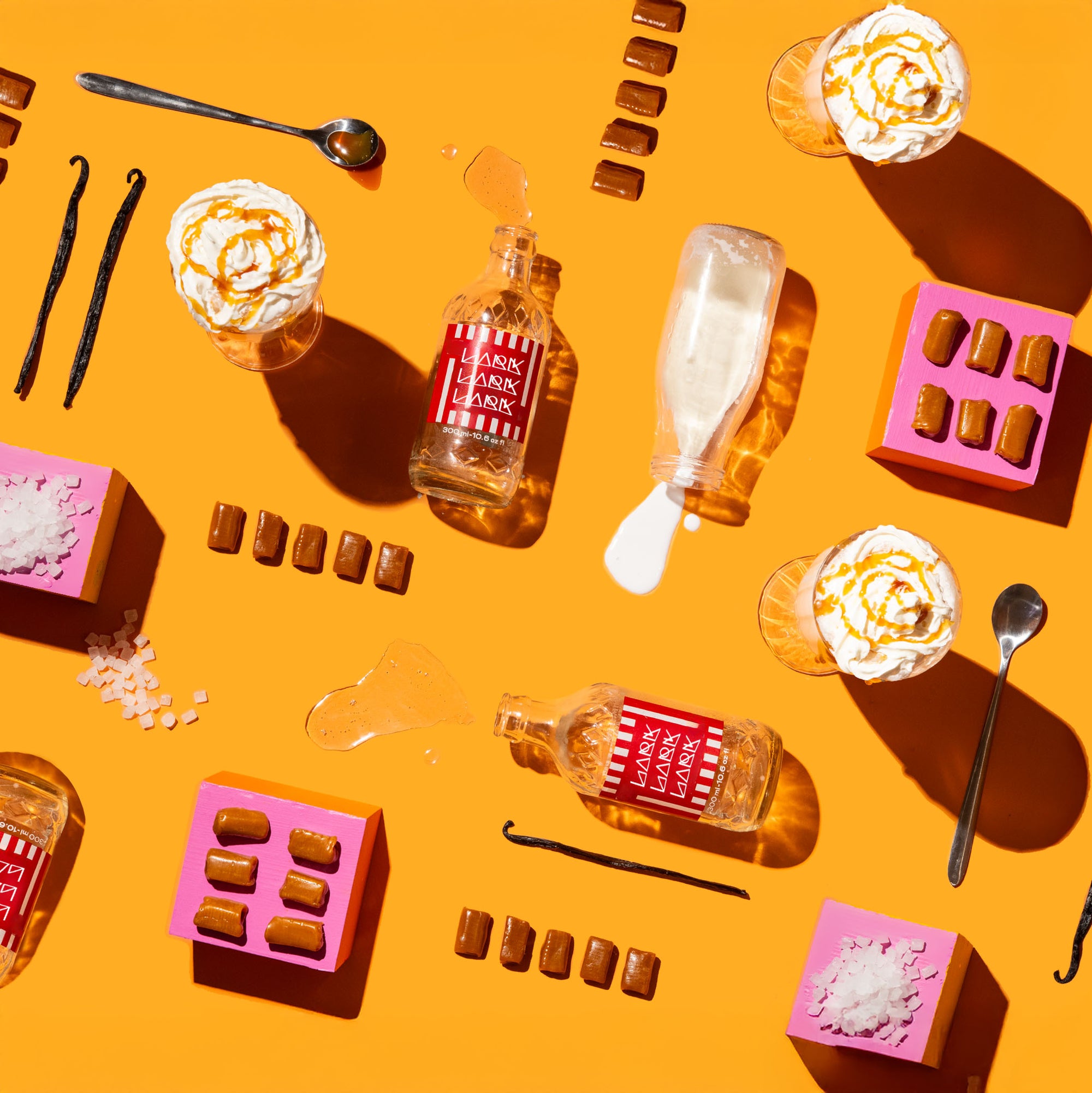 Assorted items including bottles, spoons, and desserts on a yellow background