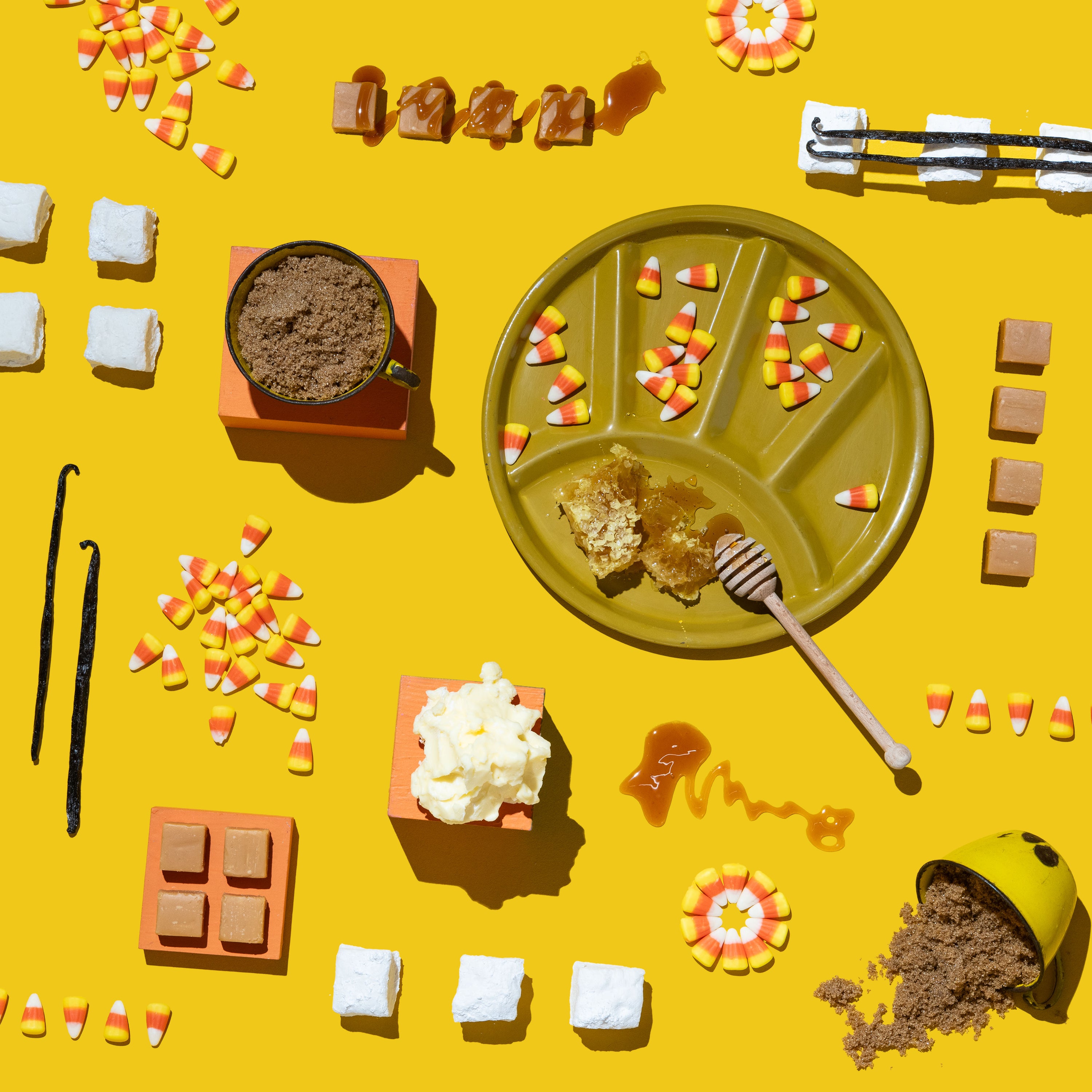 Halloween-themed treats and decorations on a yellow background