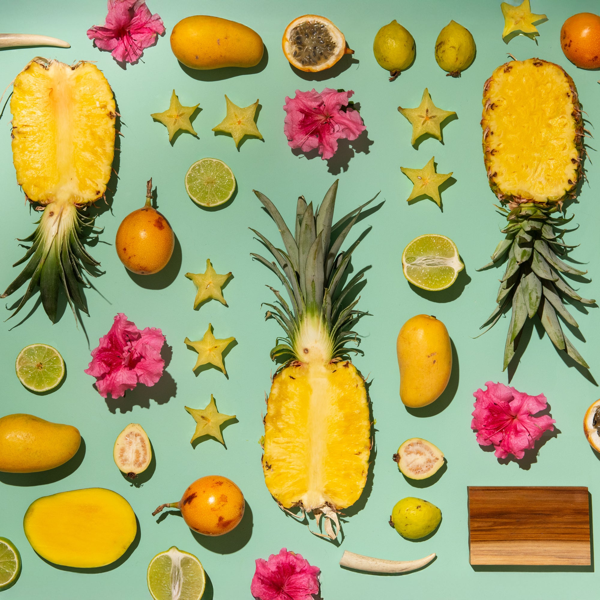 Fruits and flowers arranged on a green background