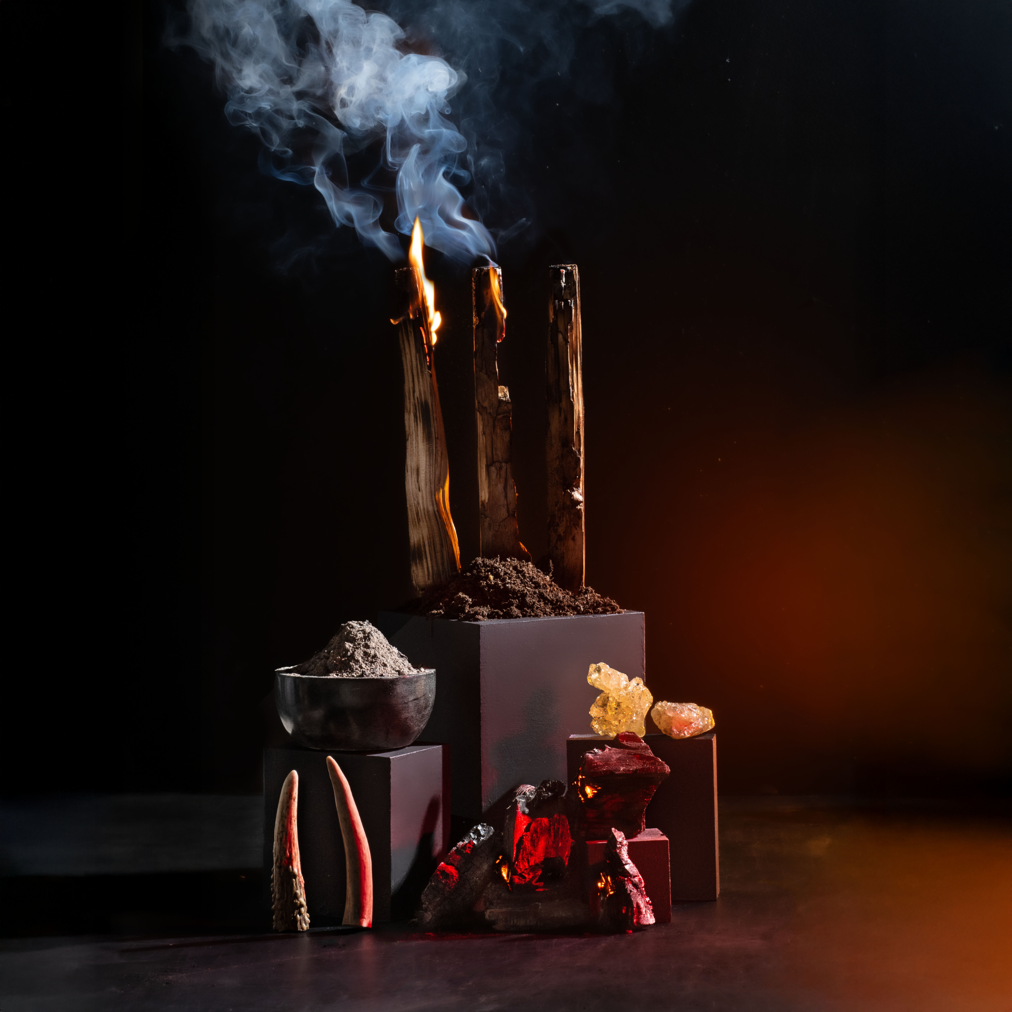 Smoldering wooden sticks with smoke, crystals, and stones on a dark background
