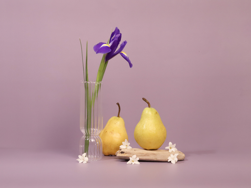 purple iris, white flowers, and pears on a purple background