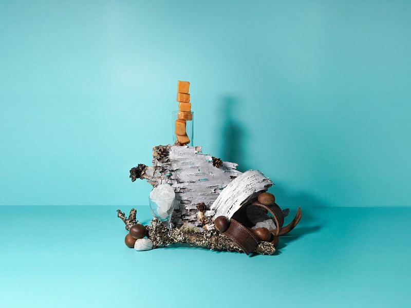 Caramel stacked high with birchwood and chestnuts around on a sky but background