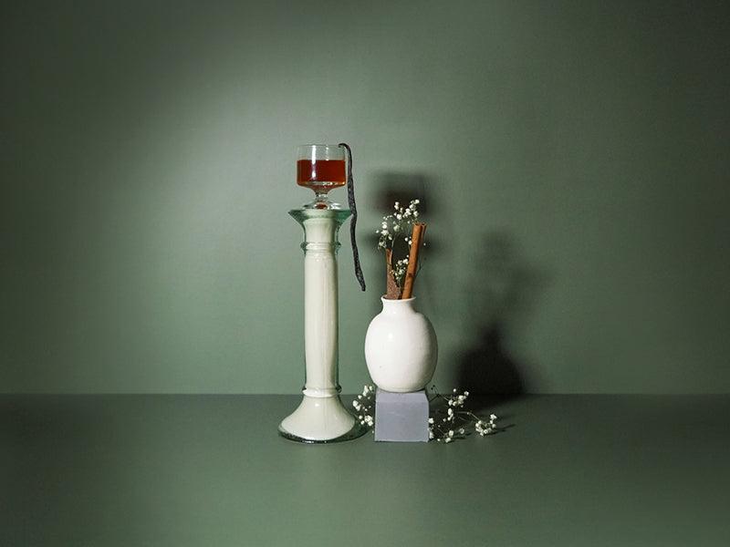 Liqueur stacked up high on a podium with cinnamon